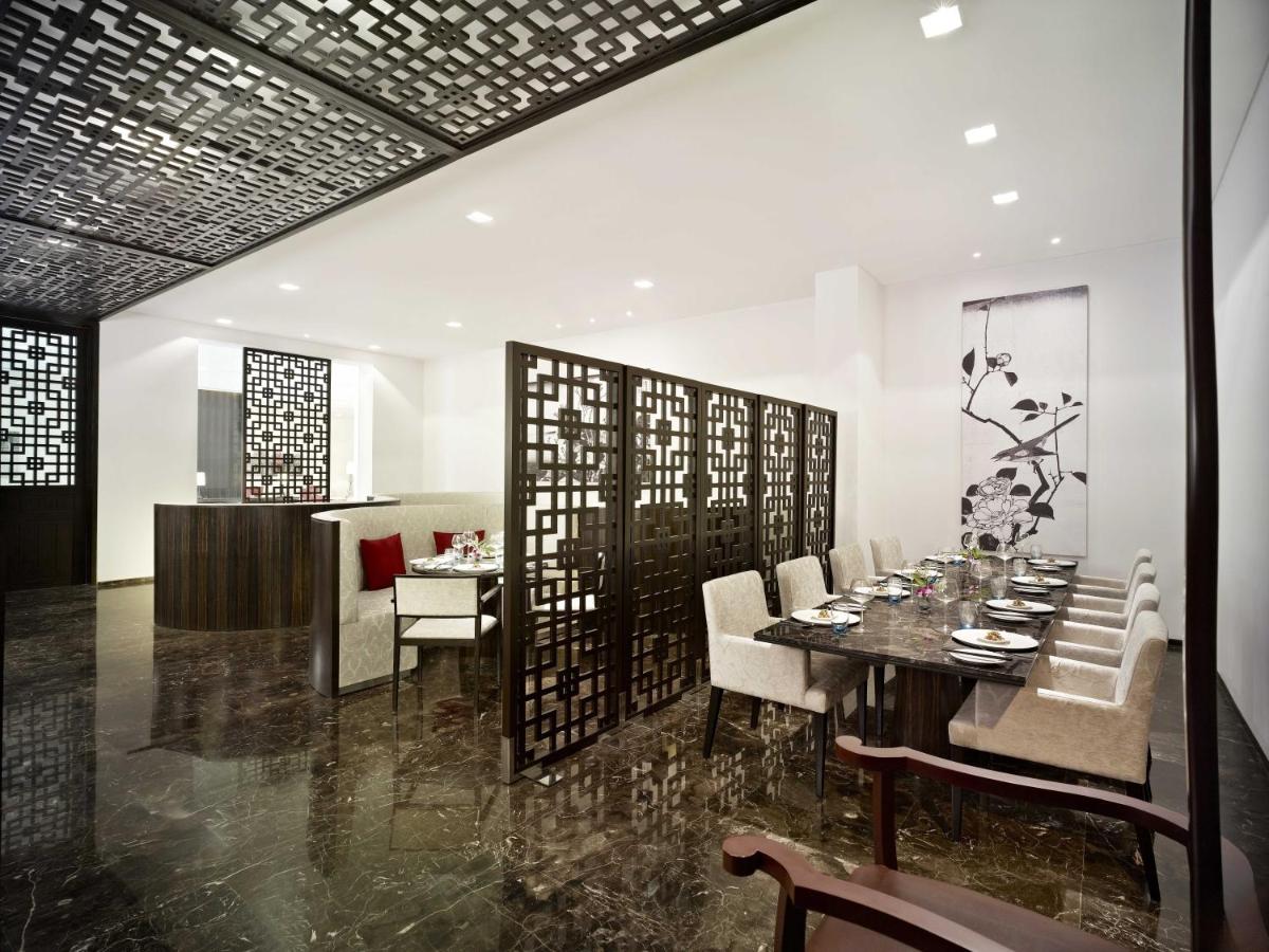 a dining room with a table and chairs at Vivanta Chennai IT Expressway OMR in Chennai
