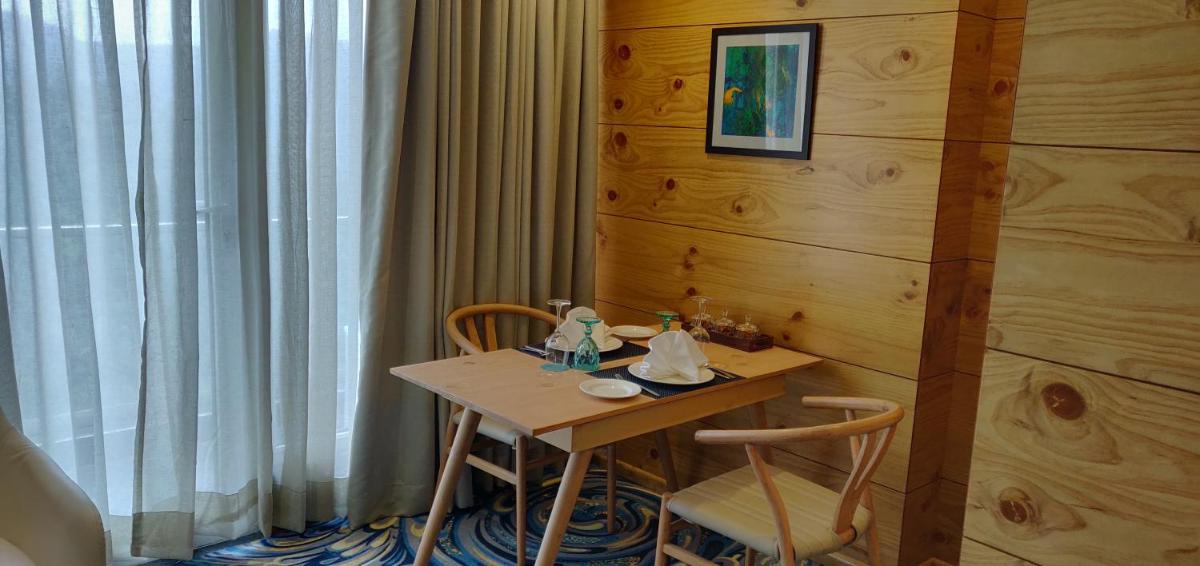 a small table and chairs in a room at Welcomhotel by ITC Hotels, Shimla in Shimla