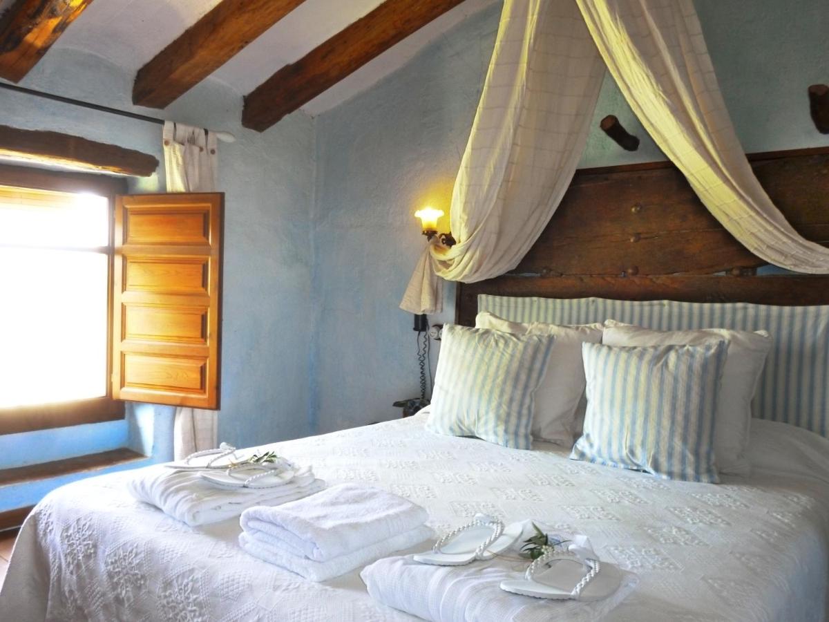 Cama o camas de una habitación en Les Vinyes Alojamiento Rural Boutique & SPA