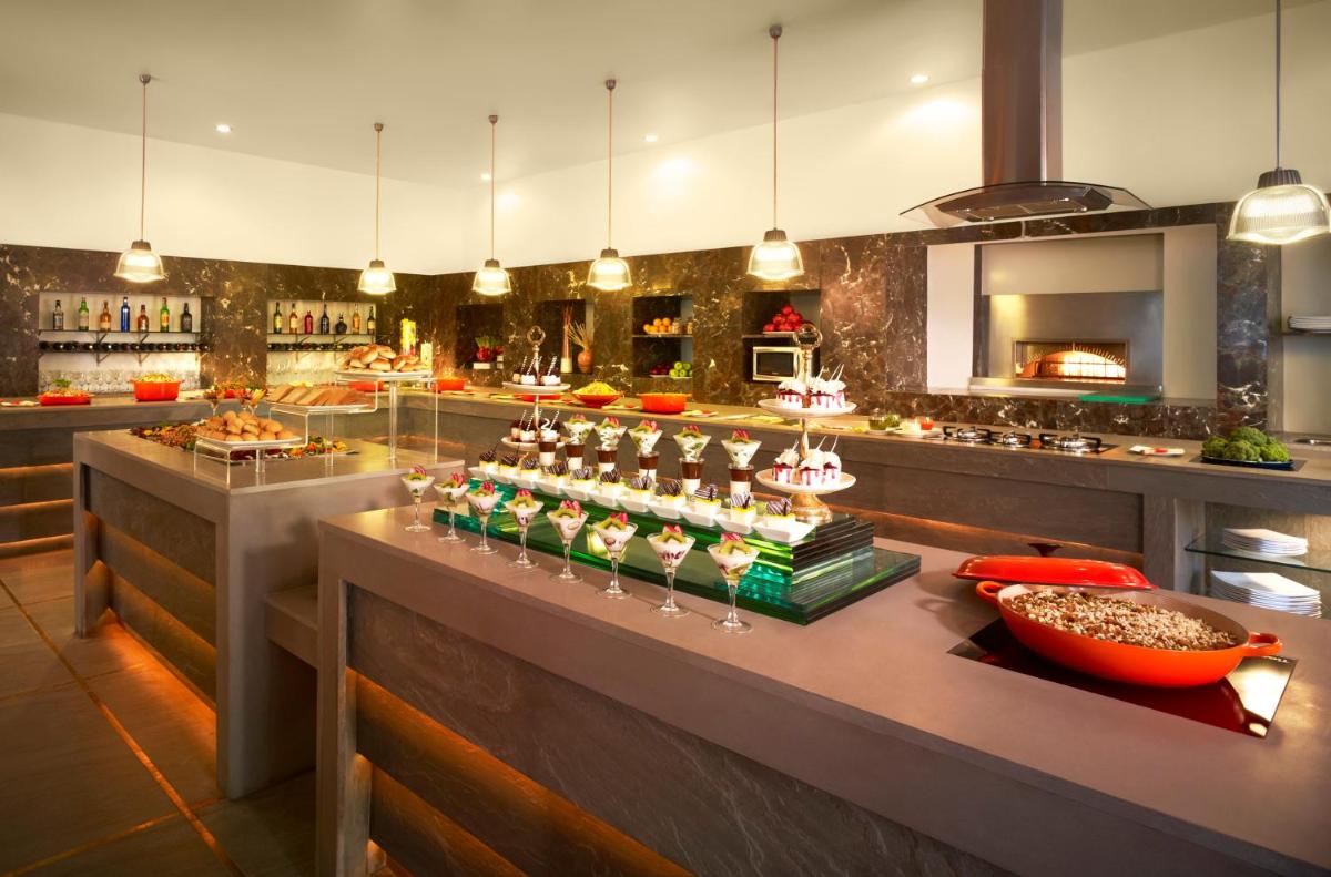 a kitchen with a counter with food on it at Taj Ganges Varanasi in Varanasi