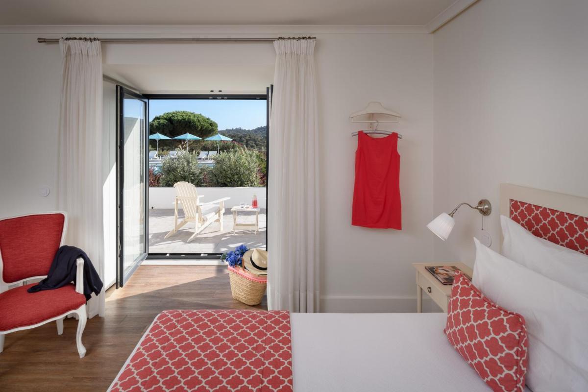 Uma cama ou camas num quarto em Hotel Casa Palmela - Small Luxury Hotels of The World, Hotel & Villas