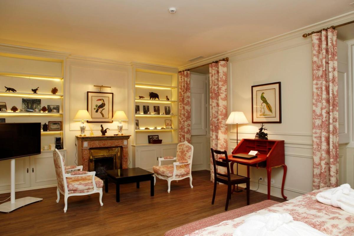 Uma cama ou camas num quarto em Hotel Casa Palmela - Small Luxury Hotels of The World, Hotel & Villas