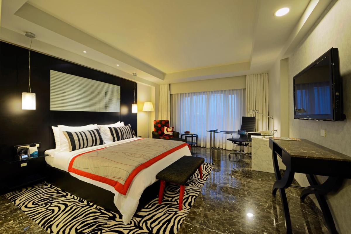 a bedroom with a large bed with a zebra rug at Radisson Blu Hotel Ahmedabad in Ahmedabad