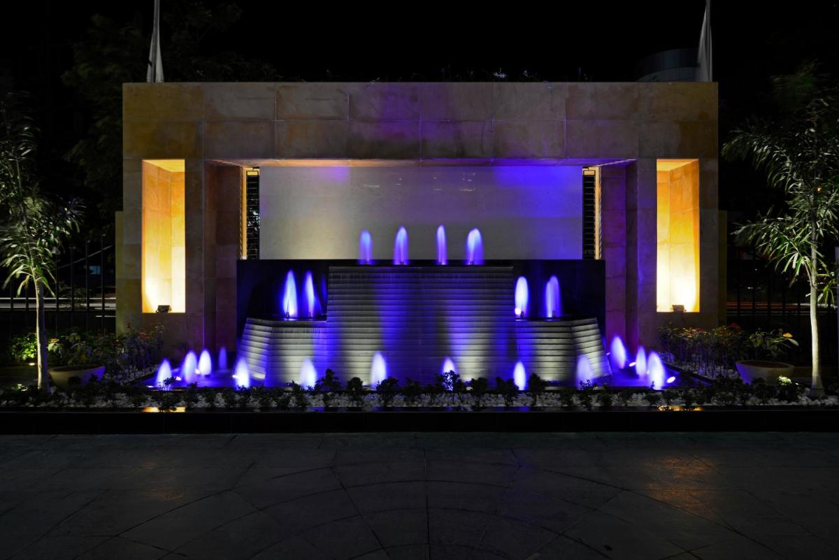 a fountain in front of a building with blue lights at Radisson Blu Hotel Ahmedabad in Ahmedabad