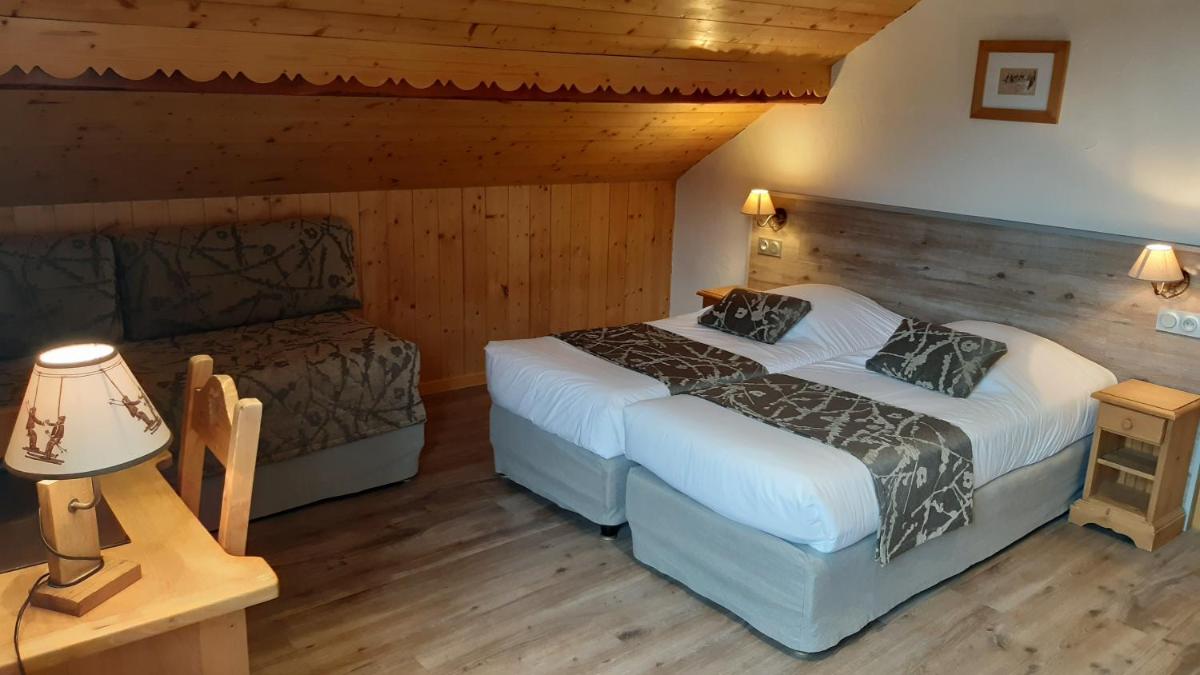 Un ou plusieurs lits dans un hébergement de l'établissement Logis Hotel & Spa Beau-Site