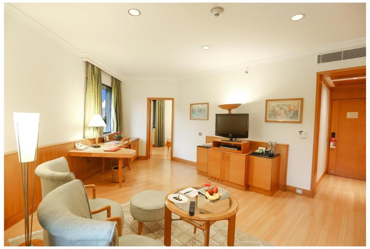 a living room with a couch and a television at Trident Chennai in Chennai