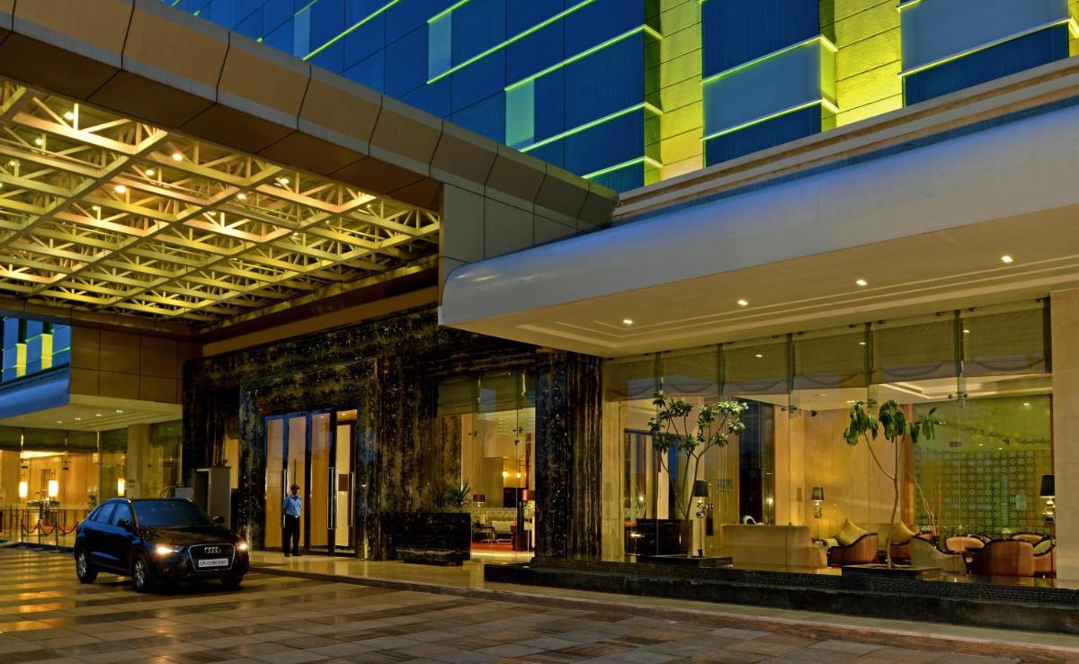 a car parked in front of a building at Radisson Blu Jaipur in Jaipur