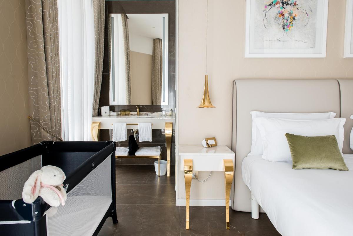 Un ou plusieurs lits dans un hébergement de l'établissement Boscolo Lyon Hotel & Spa