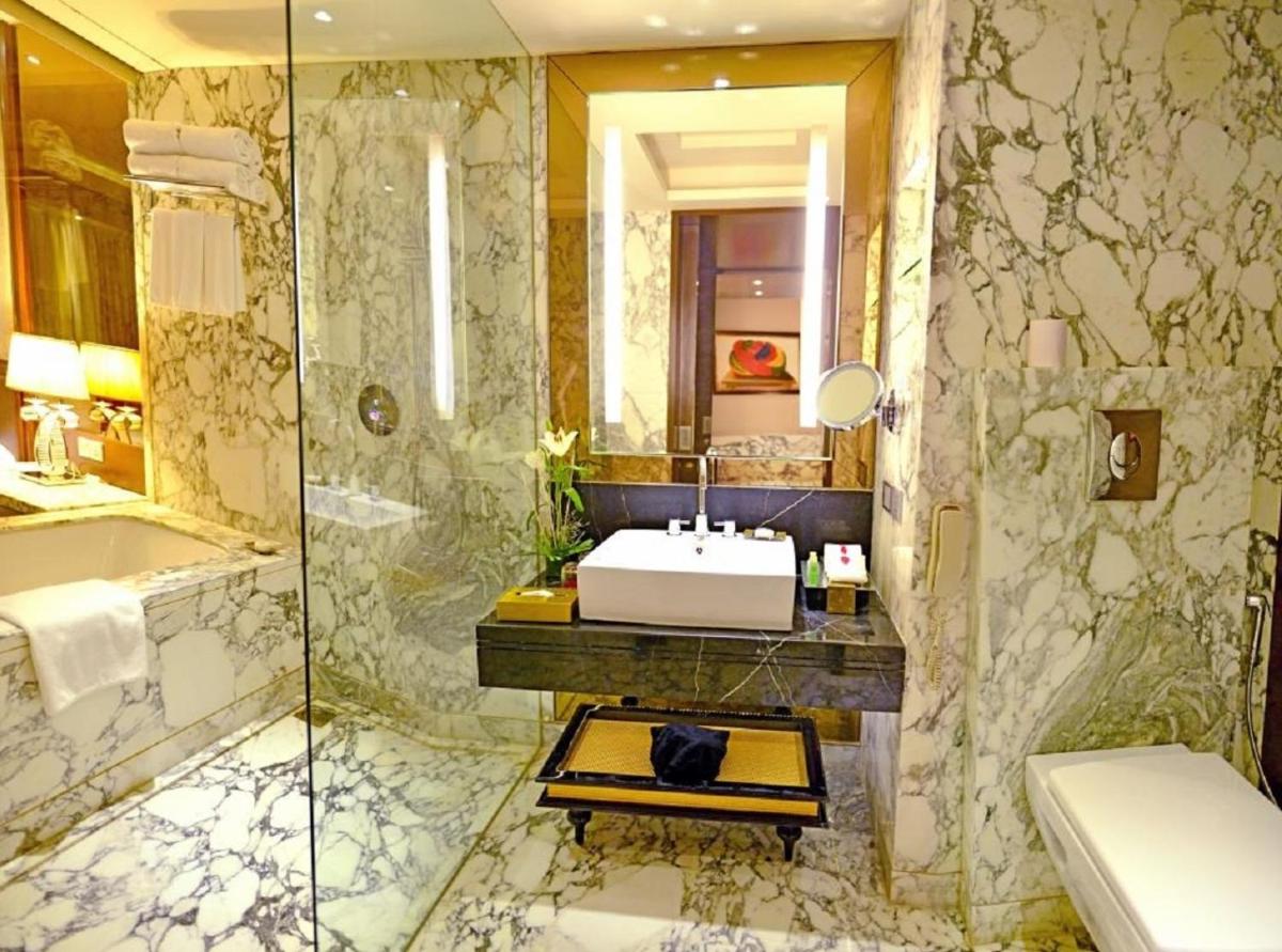 a bathroom with a sink and a shower at Radisson Blu Jaipur in Jaipur