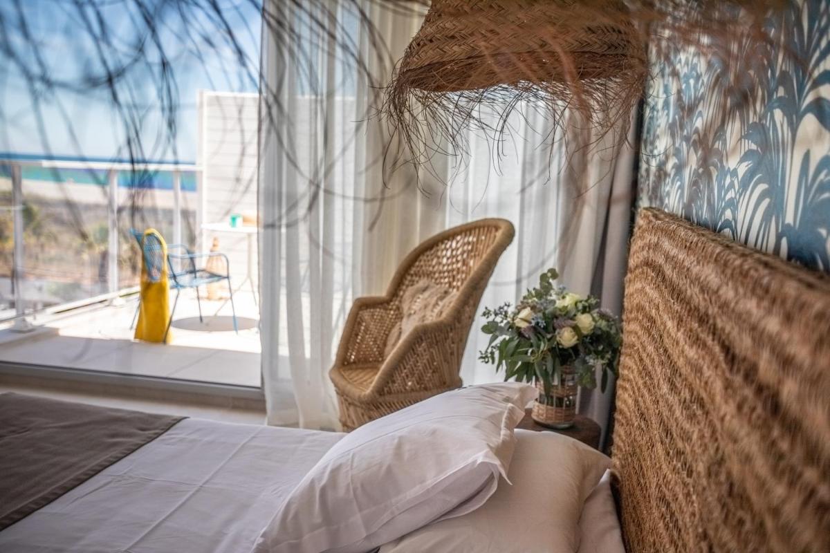 Un ou plusieurs lits dans un hébergement de l'établissement Les Bulles de Mer - Hotel & Spa sur la Plage