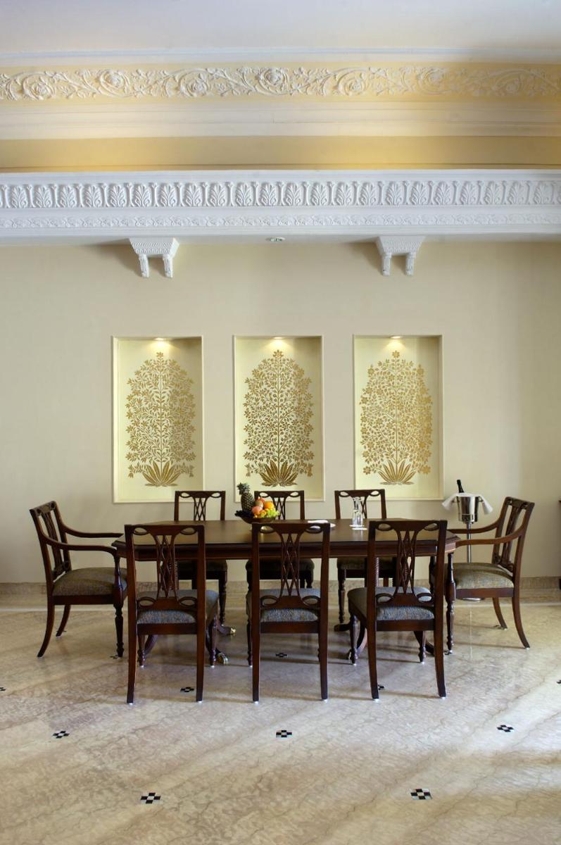 a dining room with a table and chairs at The Lalit Laxmi Vilas Palace in Udaipur