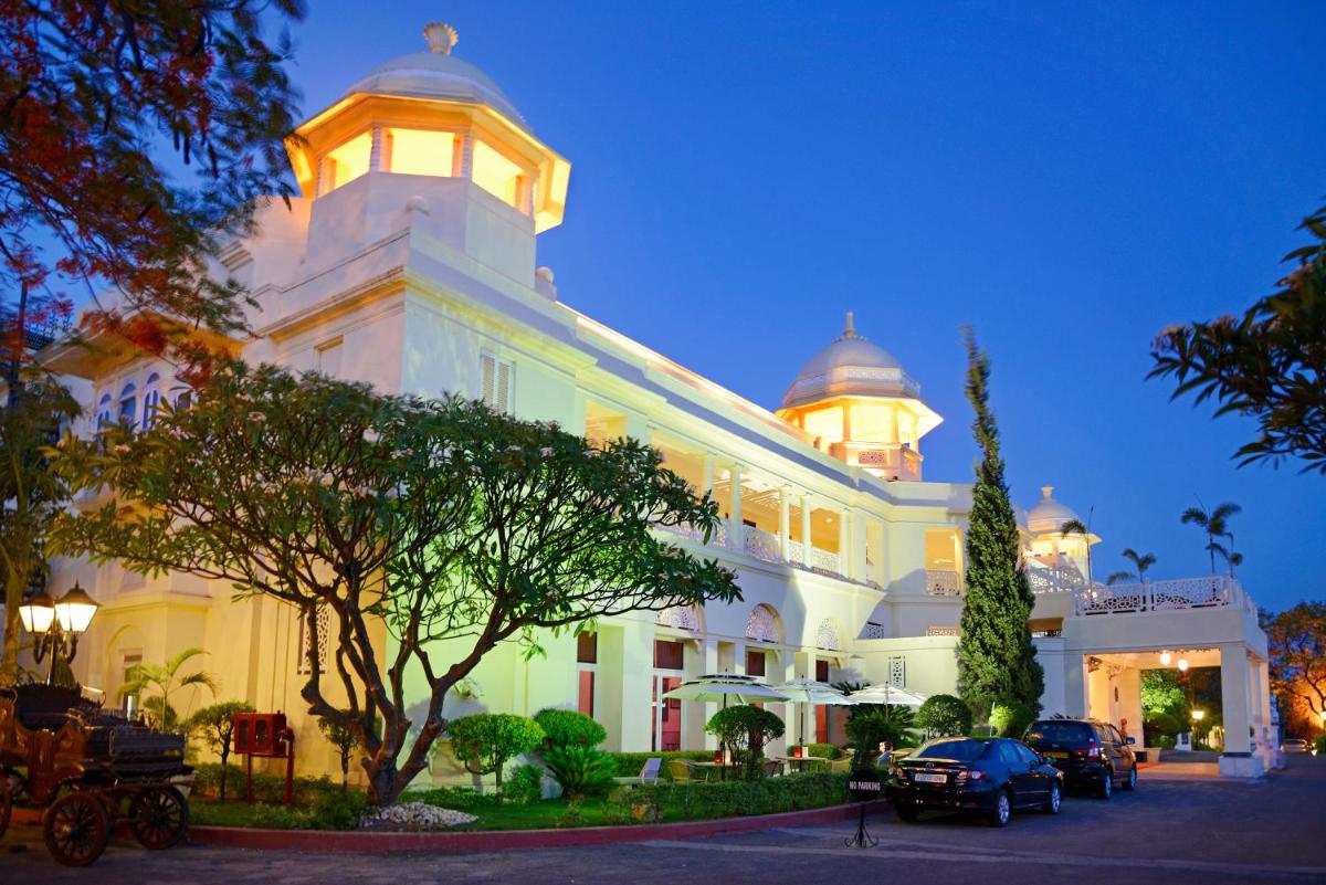 a large white building with a clock tower on top at The Lalit Laxmi Vilas Palace in Udaipur