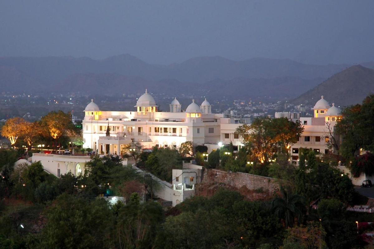 a large white building on top of a hill at The Lalit Laxmi Vilas Palace in Udaipur