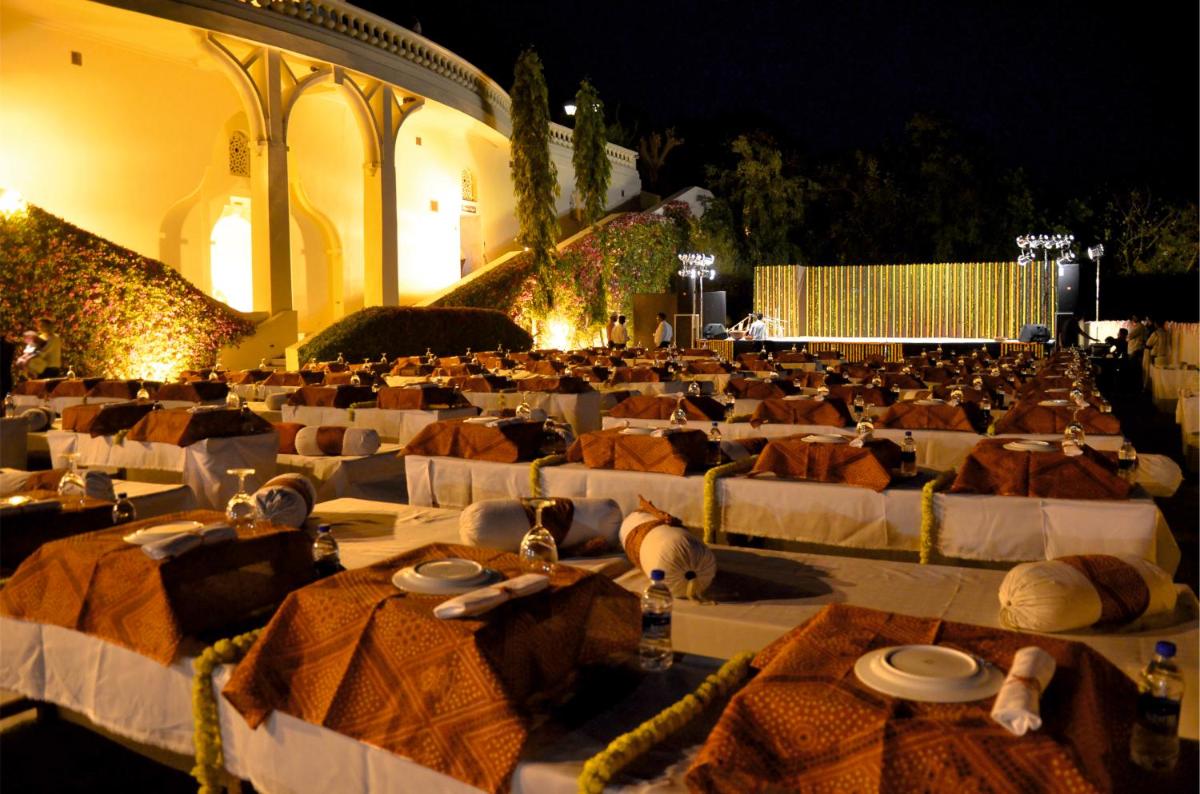 a large group of tables with food on them at The Lalit Laxmi Vilas Palace in Udaipur