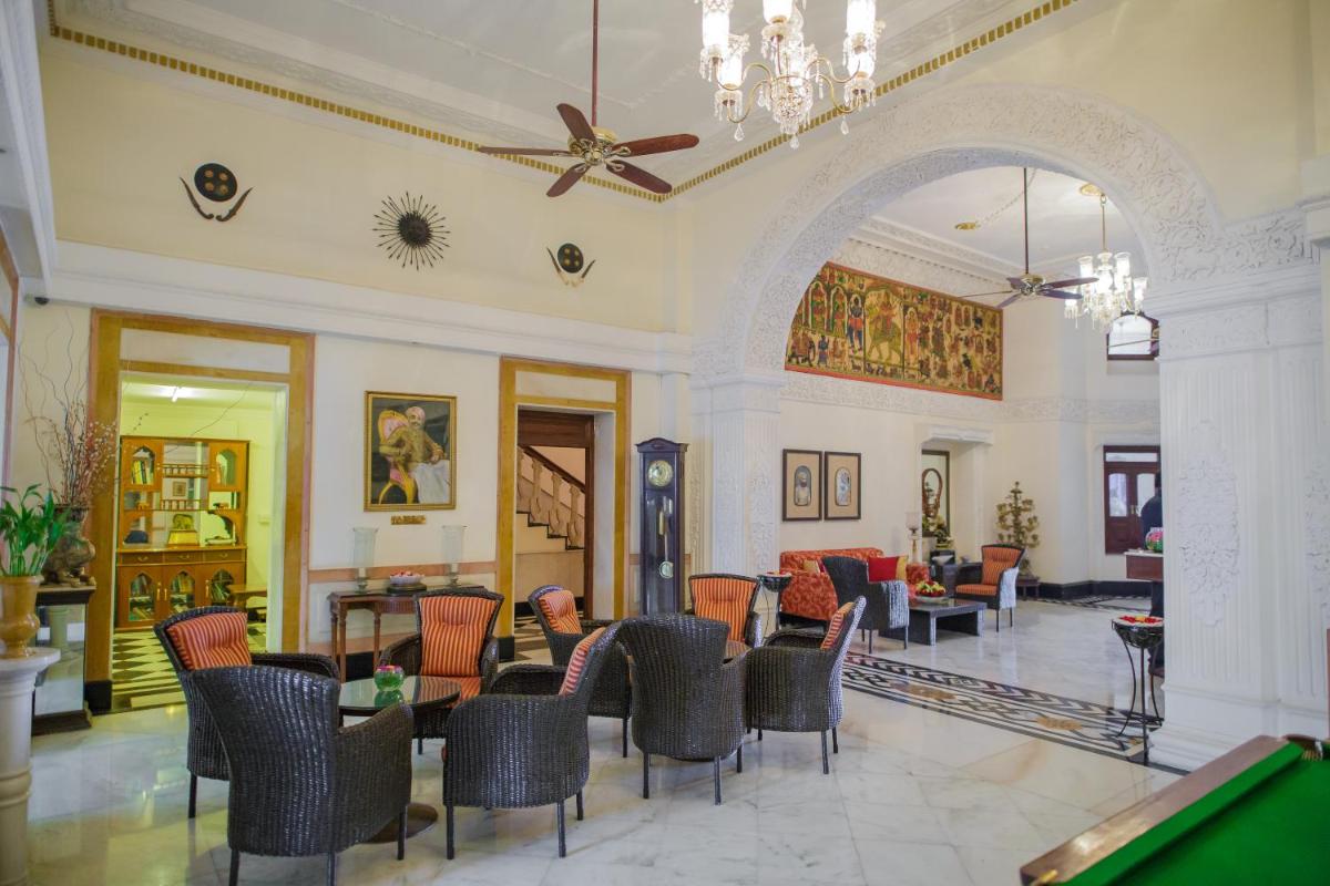 a lobby with a pool table and chairs at The Lalit Laxmi Vilas Palace in Udaipur