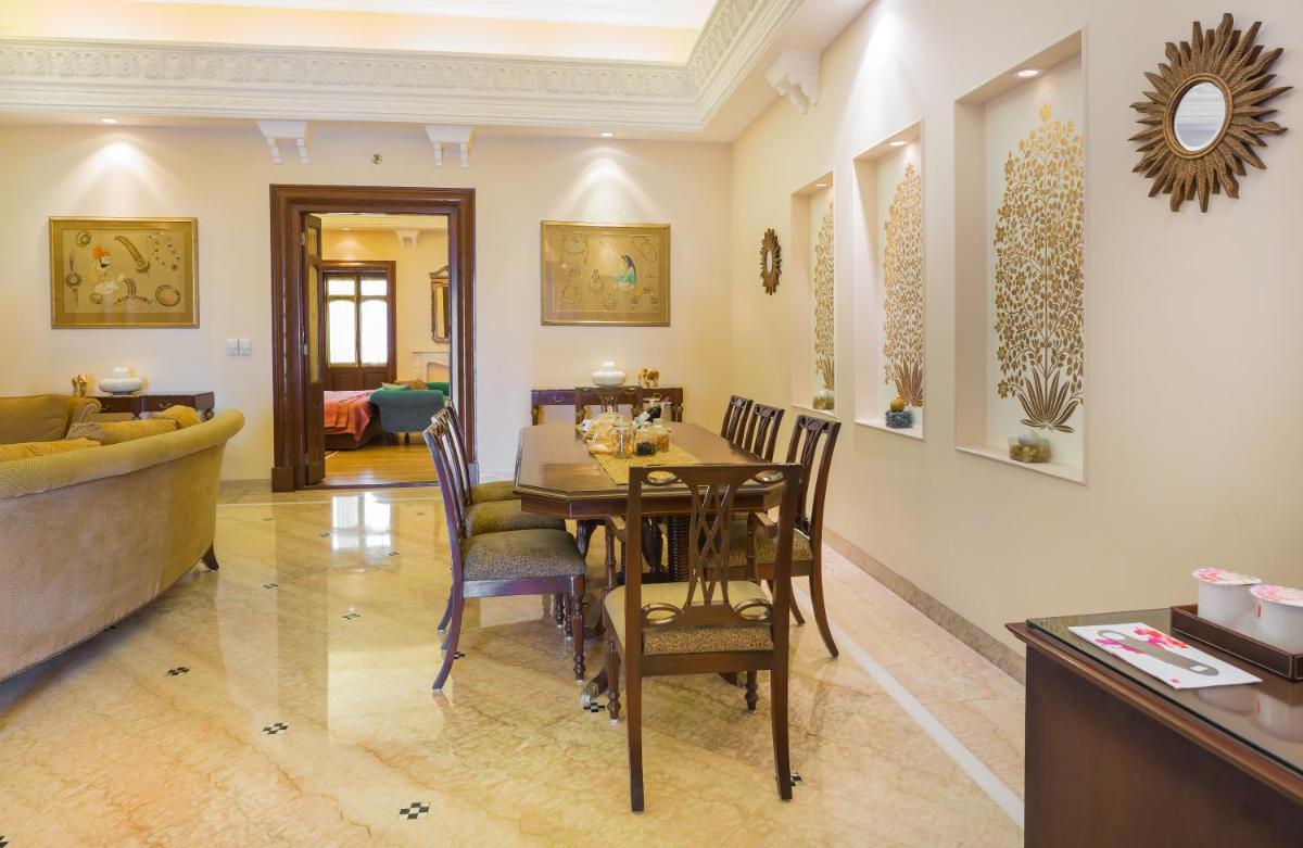 a dining room with a table and chairs at The Lalit Laxmi Vilas Palace in Udaipur