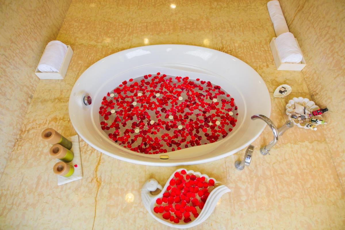 a bowl filled with red beads on top of a sink at The Lalit Laxmi Vilas Palace in Udaipur