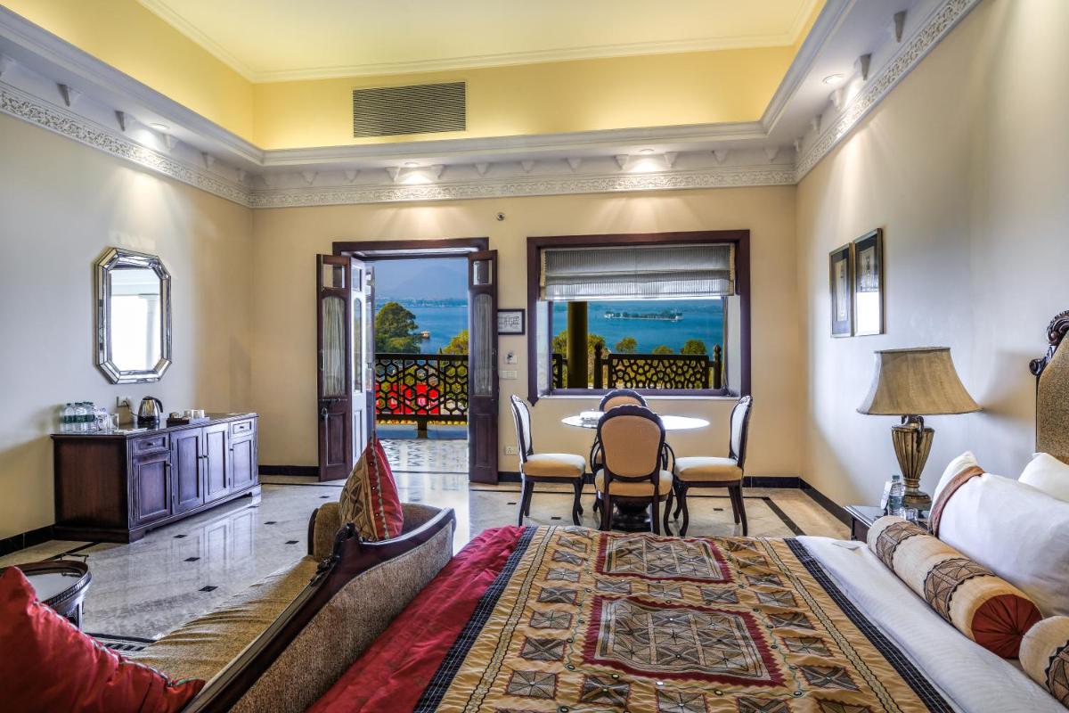 a living room with a couch and a table at The Lalit Laxmi Vilas Palace in Udaipur