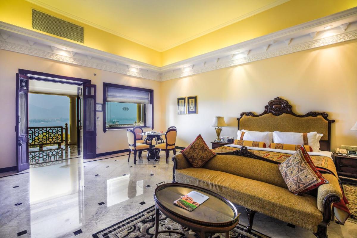 a living room with a couch and a table at The Lalit Laxmi Vilas Palace in Udaipur
