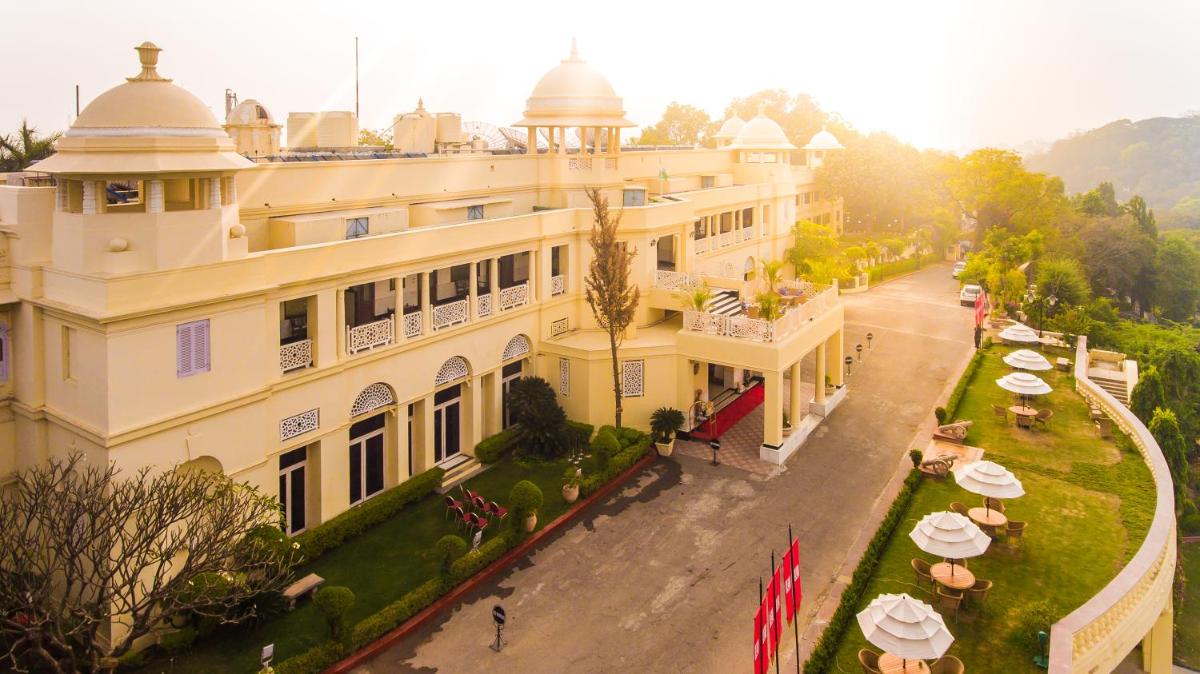 an aerial view of a building with tables and umbrellas at The Lalit Laxmi Vilas Palace in Udaipur