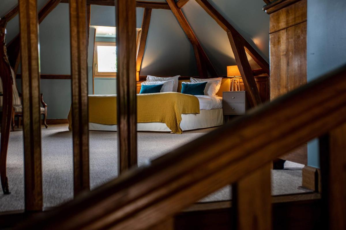 Un ou plusieurs lits dans un hébergement de l'établissement Domaine Du Roncemay - Hôtel, Restaurants, Spa & Golf