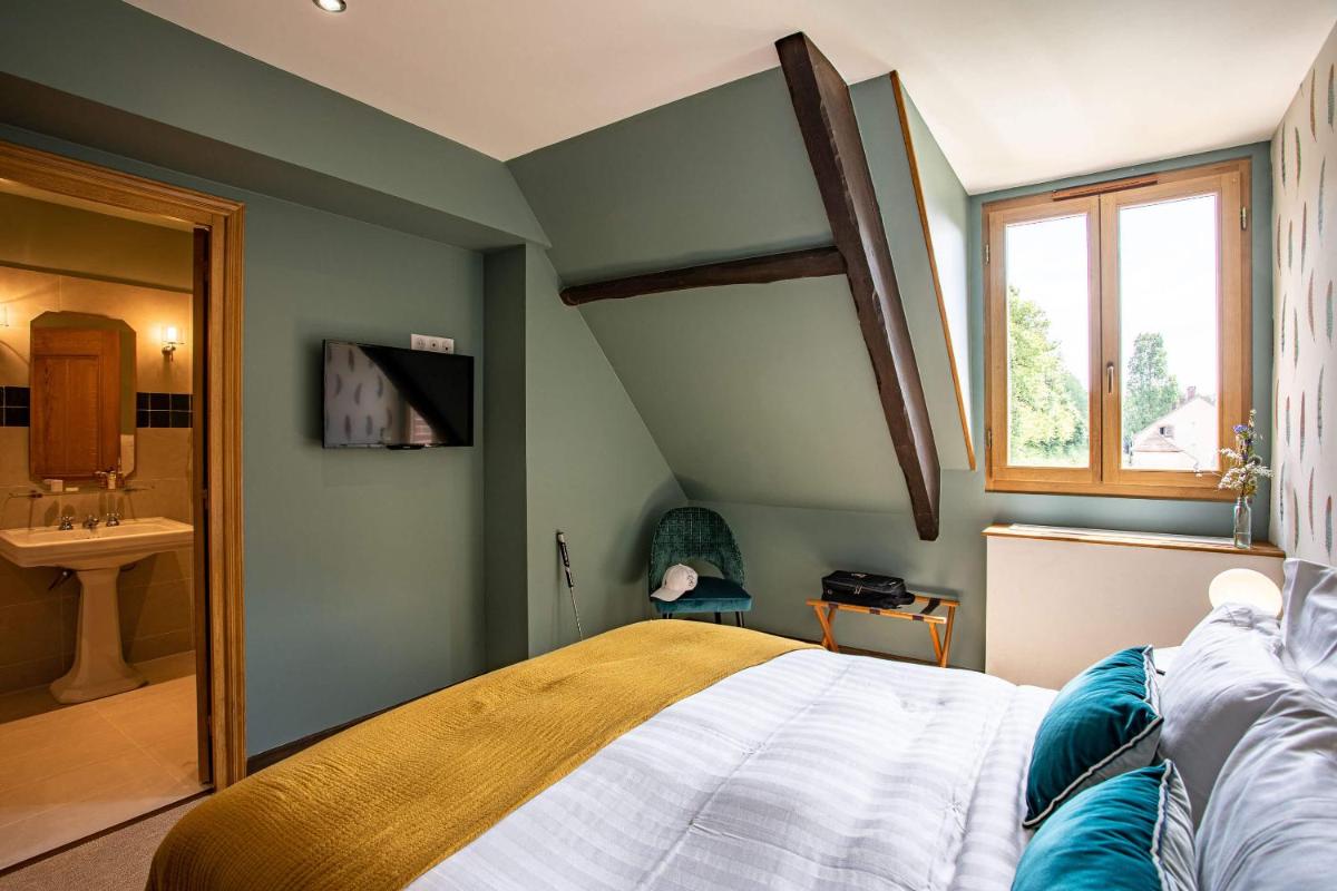 Un ou plusieurs lits dans un hébergement de l'établissement Domaine Du Roncemay - Hôtel, Restaurants, Spa & Golf