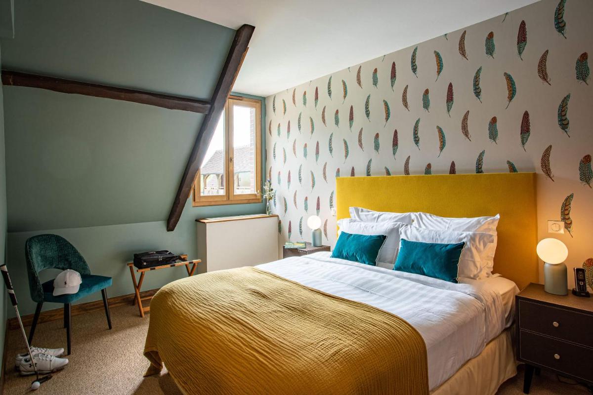 Un ou plusieurs lits dans un hébergement de l'établissement Domaine Du Roncemay - Hôtel, Restaurants, Spa & Golf