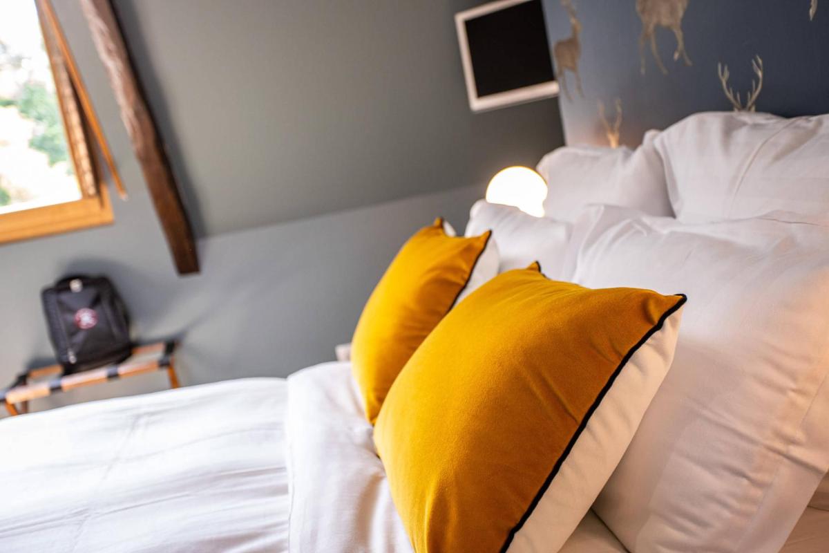 Un ou plusieurs lits dans un hébergement de l'établissement Domaine Du Roncemay - Hôtel, Restaurants, Spa & Golf