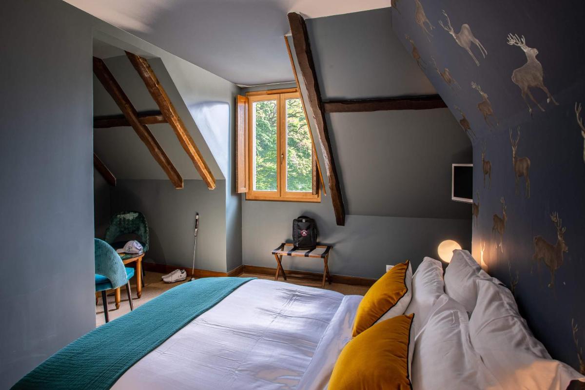 Un ou plusieurs lits dans un hébergement de l'établissement Domaine Du Roncemay - Hôtel, Restaurants, Spa & Golf