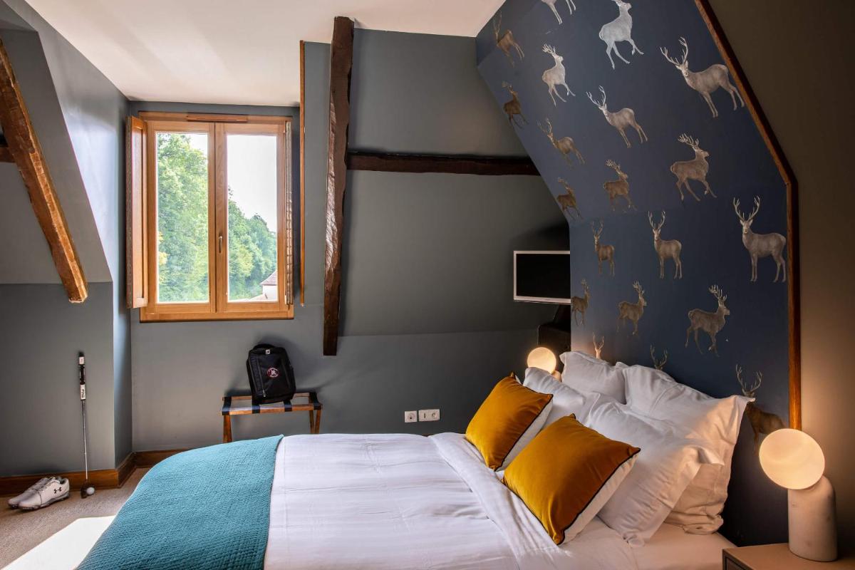 Un ou plusieurs lits dans un hébergement de l'établissement Domaine Du Roncemay - Hôtel, Restaurants, Spa & Golf
