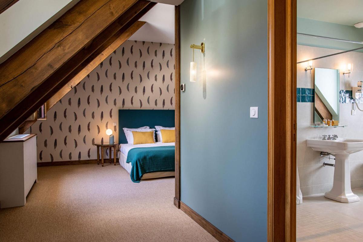 Un ou plusieurs lits dans un hébergement de l'établissement Domaine Du Roncemay - Hôtel, Restaurants, Spa & Golf
