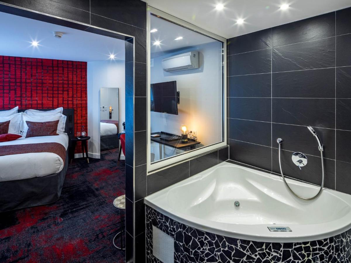 Un ou plusieurs lits dans un hébergement de l'établissement Hôtel Villa La Florangerie - SPA & Piscine