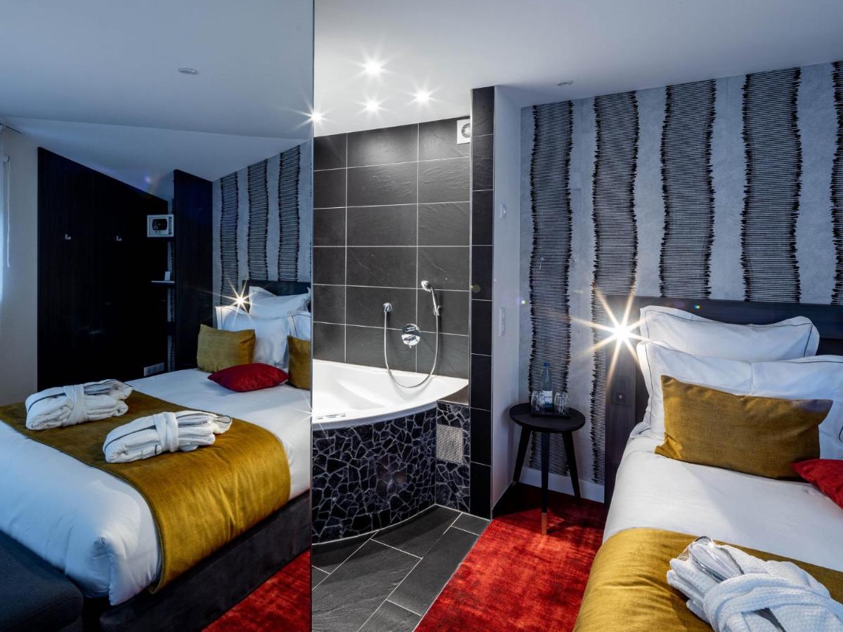 Un ou plusieurs lits dans un hébergement de l'établissement Hôtel Villa La Florangerie - SPA & Piscine