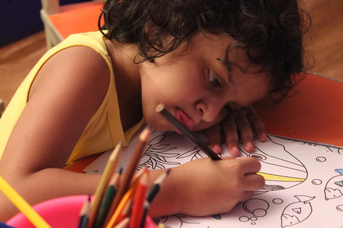 a young girl drawing a picture on a table at Novotel Goa Candolim in Candolim a young girl drawing a picture on a table at Novotel Goa Candolim in Candolim
