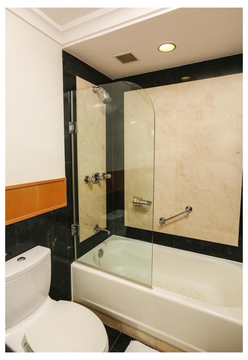 a bathroom with a toilet and a glass shower at Trident Chennai in Chennai