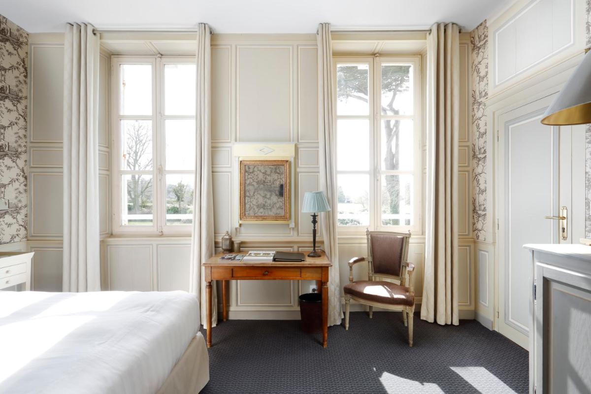 Un ou plusieurs lits dans un hébergement de l'établissement Chateau La Cheneviere