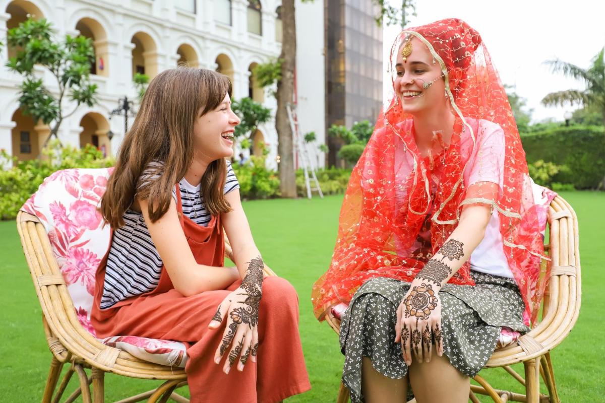 two girls sitting in chairs on the grass at The Grand Imperial - Heritage Hotel in Agra