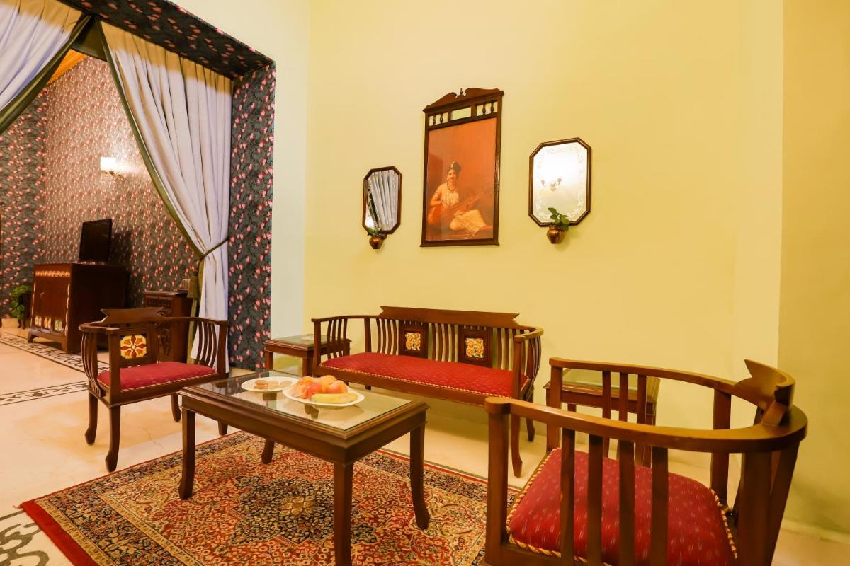 a living room with two chairs and a table at The Grand Imperial - Heritage Hotel in Agra