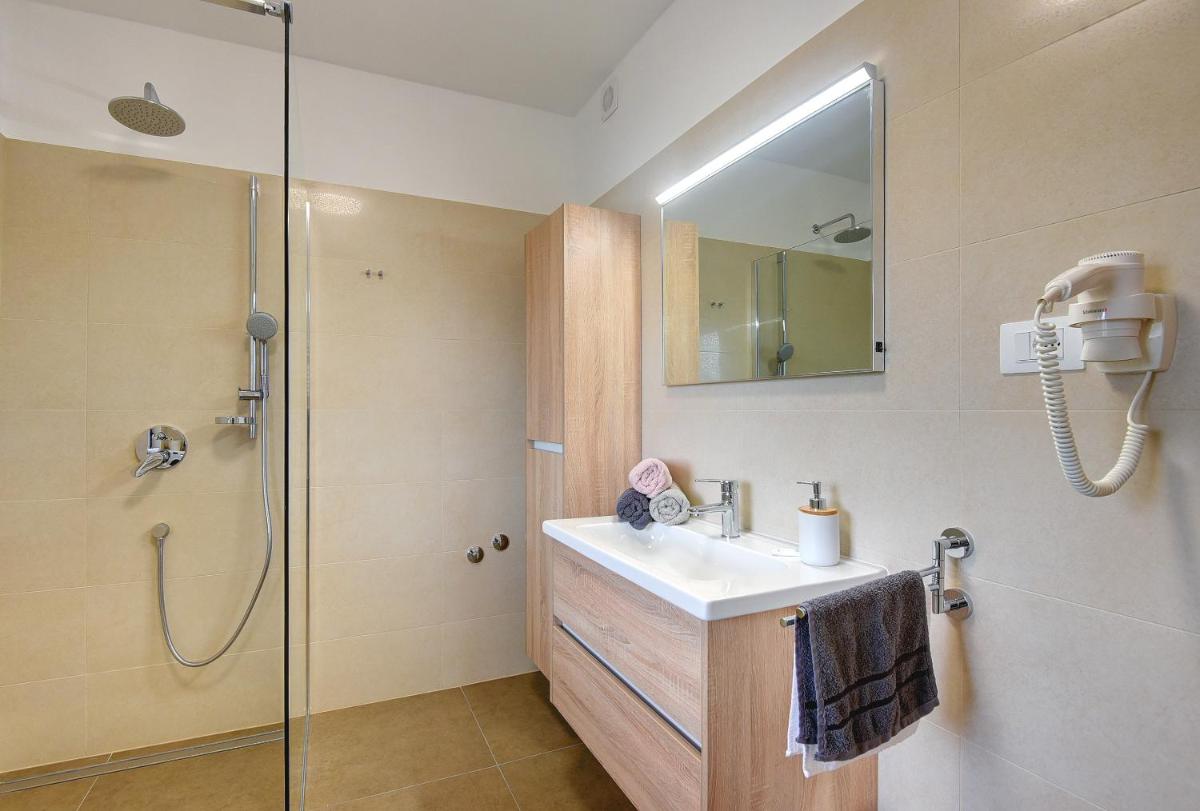 Villa Andrija Family Dream with heated pool at the sea with beautiful garden, outside cinema and kids playground - Housity