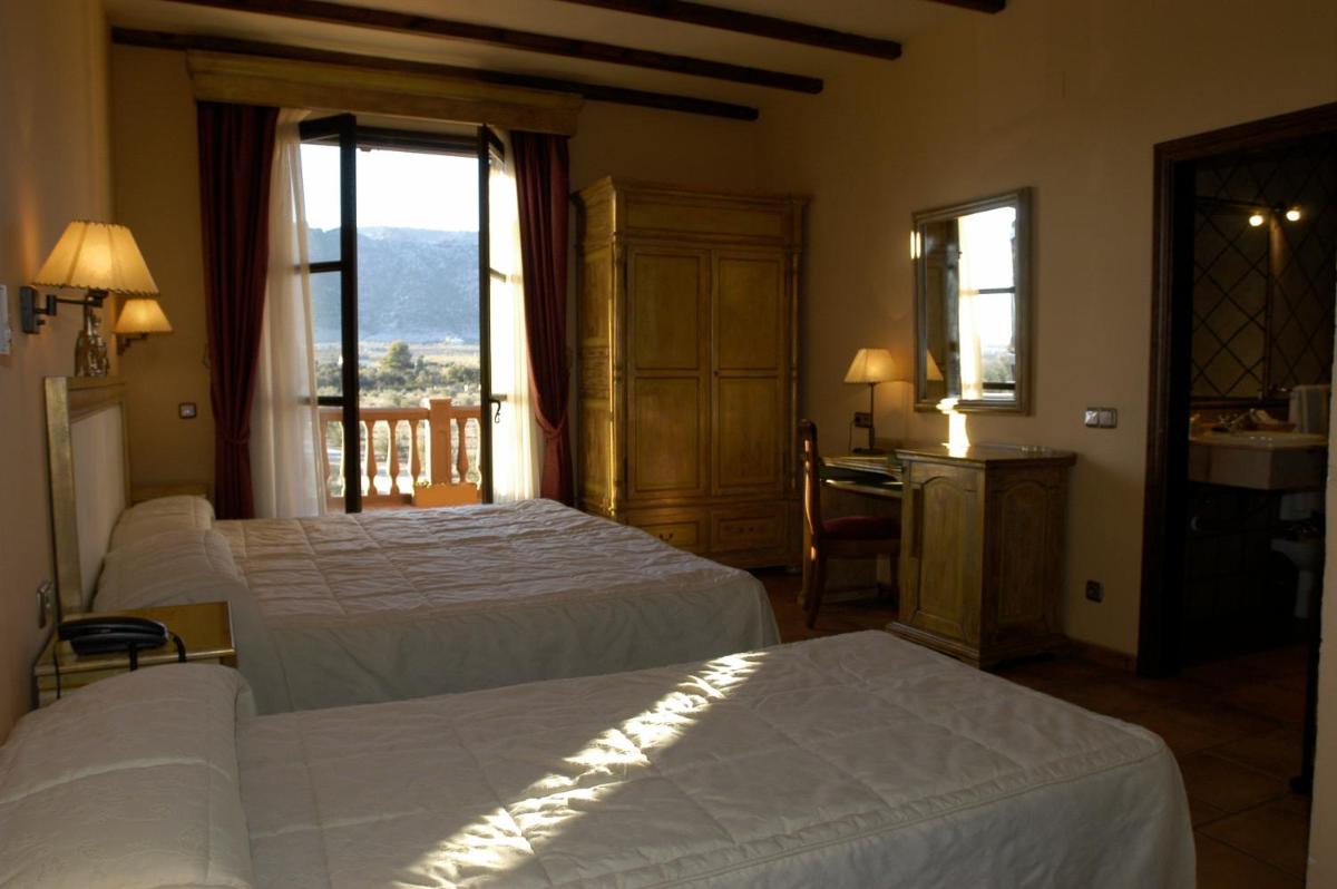 Cama o camas de una habitación en Hotel Rural Los Nogales