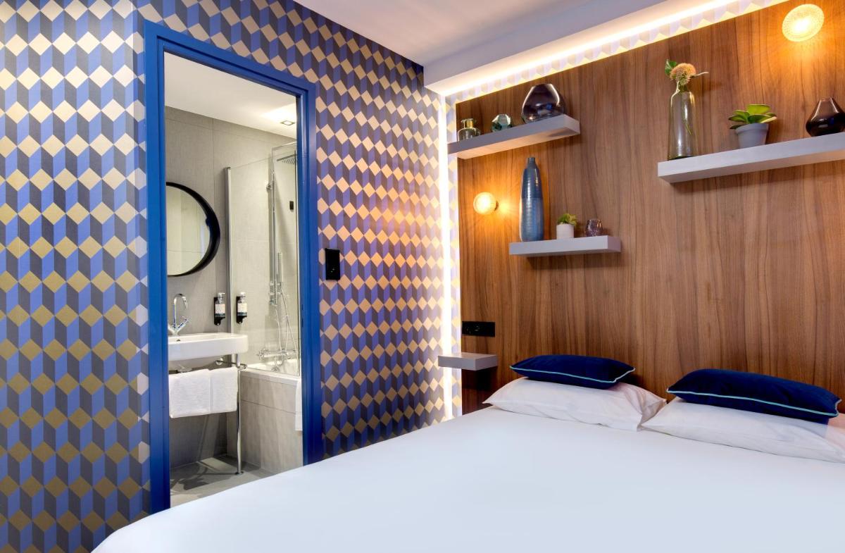 Un ou plusieurs lits dans un hébergement de l'établissement Hôtel Montmorency & Spa