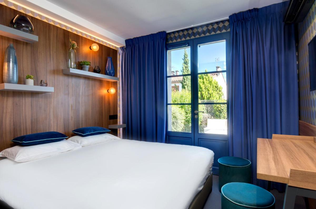 Un ou plusieurs lits dans un hébergement de l'établissement Hôtel Montmorency & Spa