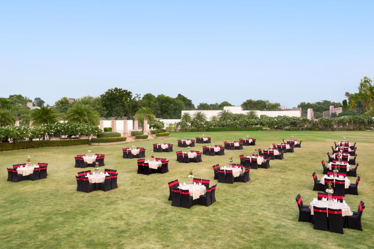 a group of tables set up in a field at Ramada Plaza by Wyndham Lucknow in Lucknow