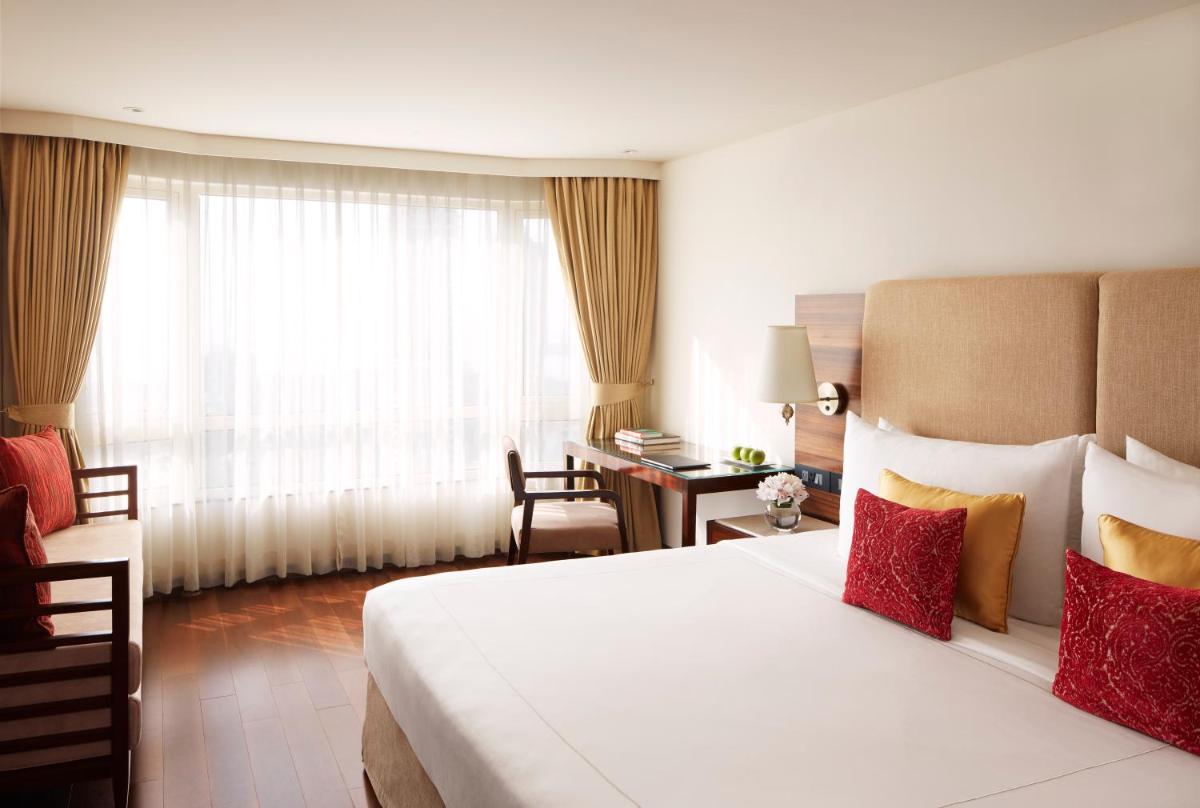 a hotel room with a large bed and a desk at President - IHCL SeleQtions in Mumbai