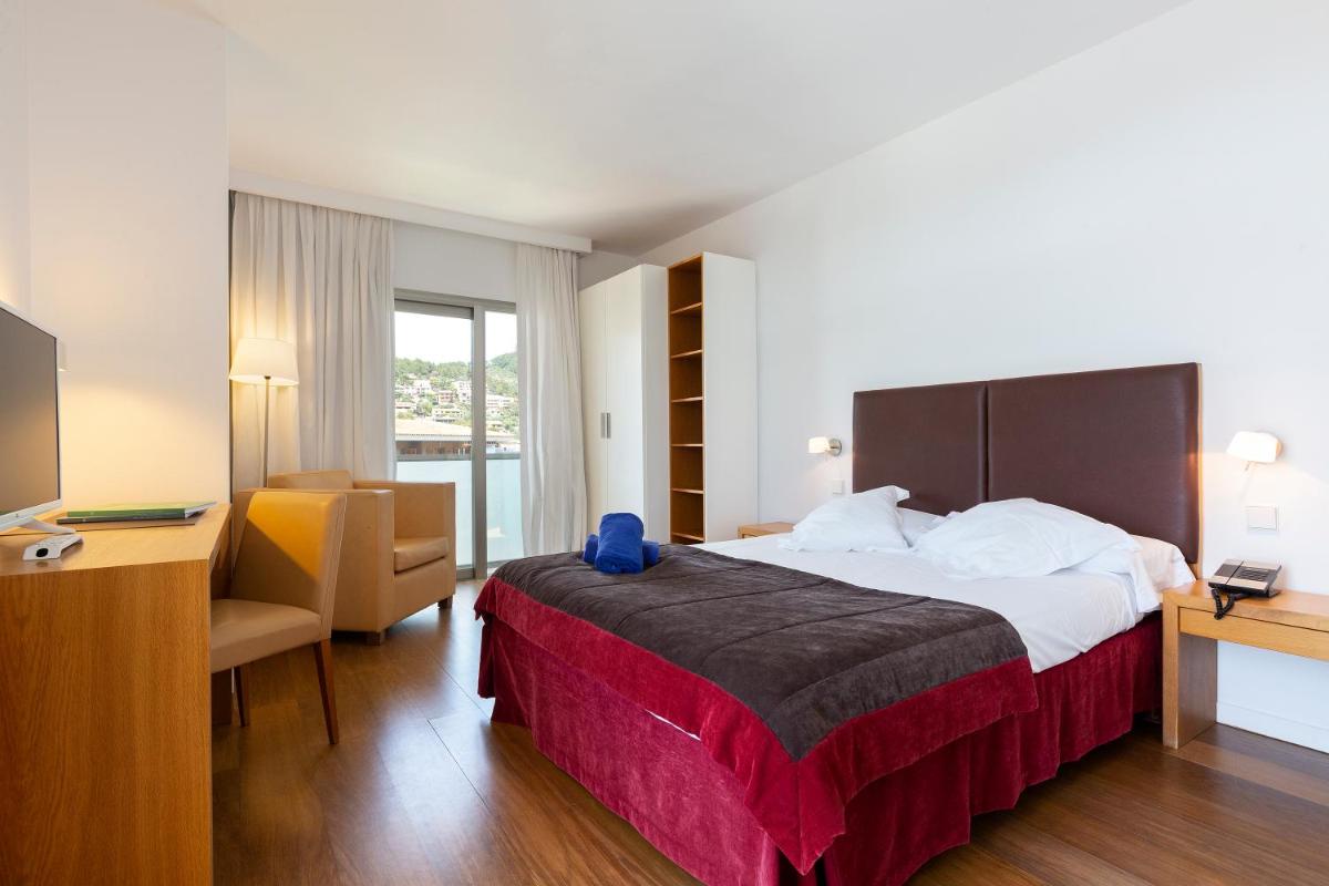 Cama o camas de una habitación en Aimia Hotel