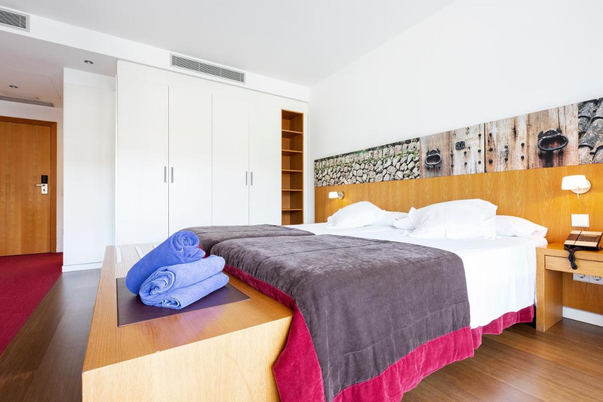 Cama o camas de una habitación en Aimia Hotel