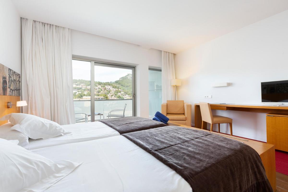 Cama o camas de una habitación en Aimia Hotel