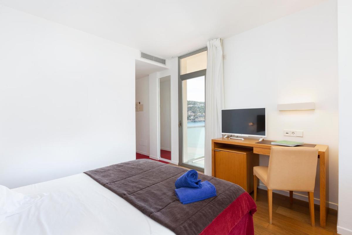 Cama o camas de una habitación en Aimia Hotel