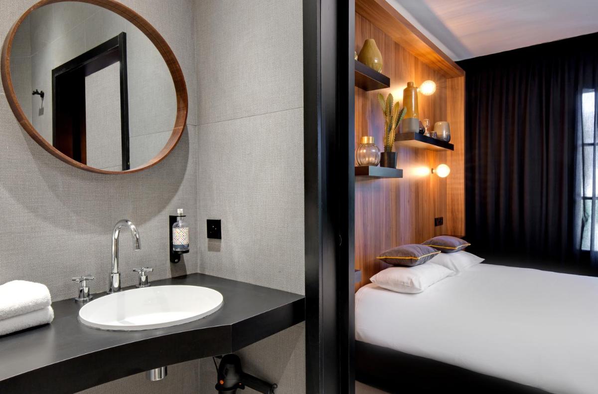 Un ou plusieurs lits dans un hébergement de l'établissement Hôtel Montmorency & Spa