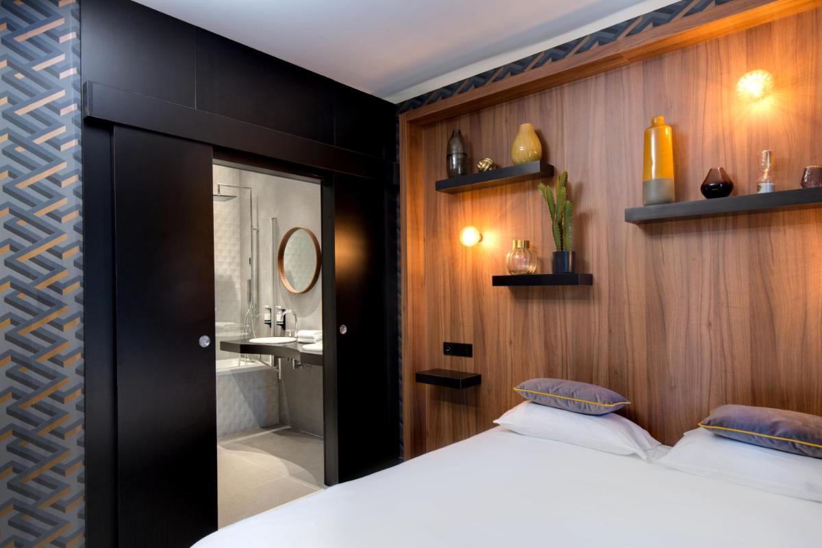 Un ou plusieurs lits dans un hébergement de l'établissement Hôtel Montmorency & Spa